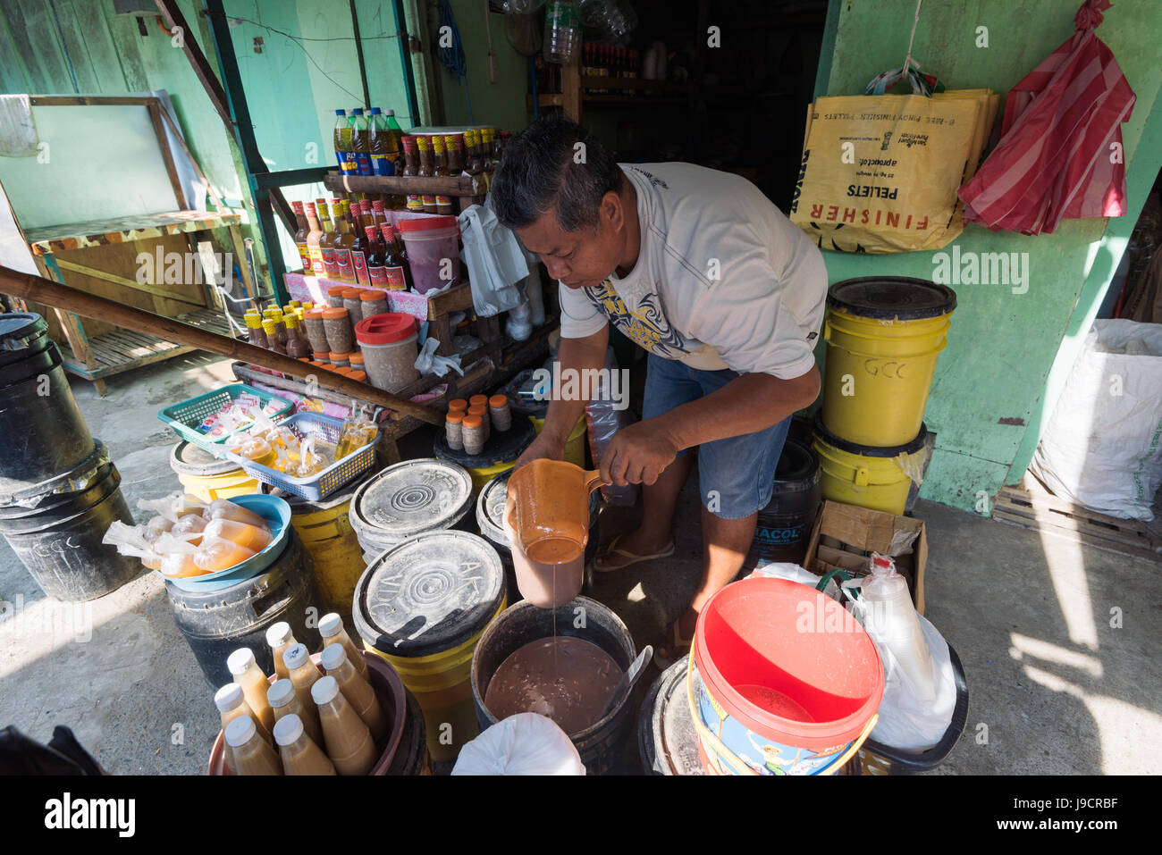 Bolinao, Philippines - April 14, 2017: Man selling `Bagoong` a fermented fish at the Bolinao Wet Market in Pangasinan, Philippines. Stock Photo